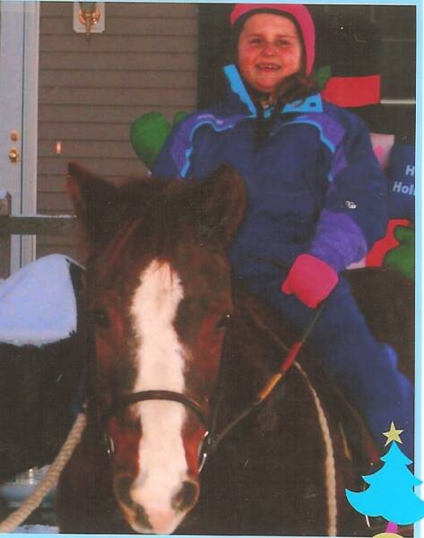 Chloe posing for a Christmas card with her young rider this past holiday season