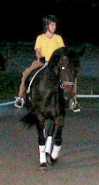 Student Val riding R.C. "under the lights" one evening - when it was tooooo hot to ride during the day!